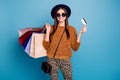 Portrait of positive tourist girl money payer walk autumn winter shop mall retail hold credit card wear brown sweater
