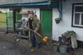 positive Ukrainian country man d trying to clean his dirt from rotten pumpkin Royalty Free Stock Photo