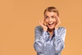 Portrait of positive woman with blonde short hair, surprised expression on the face, happy eyes and gentle smile. Cheerful woman. Royalty Free Stock Photo