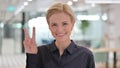 Portrait of Positive Young Businesswoman showing Victory Sign by Hand Royalty Free Stock Photo