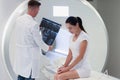 Practitioner looking at mri picture, female patient at medical consultation