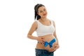 Portrait of pregnant brunette in white shirt with blue tape on her belly looking and smiling on camera isolated on white Royalty Free Stock Photo