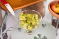 Portrait of pregnant mother cuts kiwi fruit Royalty Free Stock Photo