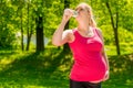 Portrait of a pregnant woman drinking fresh water from a bottle Royalty Free Stock Photo