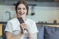 Portrait of a pregnant woman eating a bar of delicious chocolate, sweets. Sitting on the couch at home in home clothes, looking at Royalty Free Stock Photo