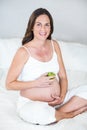 Portrait of pregnant woman with Granny Smith apple Royalty Free Stock Photo