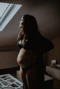 Portrait of a pregnant woman looking outside