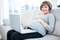 Portrait of pregnant woman using laptop Royalty Free Stock Photo
