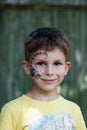 Portrait of preschool boy with painted scorpion on his face. Festive face painting.