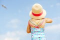 Portrait of preschool girl in colorful swimmsuit and straw hat. Cute happy toddler child on family vacations on the sea Royalty Free Stock Photo