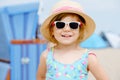 Portrait of preschool girl in colorful swimmsuit and straw hat. Cute happy toddler child on family vacations on the sea Royalty Free Stock Photo
