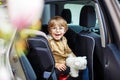 Portrait of preschool kid boy sitting in car