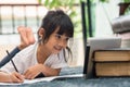 Portrait of preschool kid using tablet for his homework,Soft focus of Child doing homework by using digital tablet searching Royalty Free Stock Photo