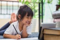 Portrait of preschool kid using tablet for his homework,Soft focus of Child doing homework by using digital tablet searching Royalty Free Stock Photo