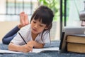 Portrait of preschool kid using tablet for his homework,Soft focus of Child doing homework by using digital tablet searching Royalty Free Stock Photo