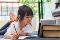 Portrait of preschool kid using tablet for his homework,Soft focus of Child doing homework by using digital tablet searching Royalty Free Stock Photo