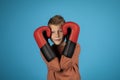 Portrait Of Preteen Blonde Boy Covering Ears With Boxing Gloves Royalty Free Stock Photo