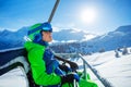 Portrait of a preteen boy with ski helmet and mask on chairlift Royalty Free Stock Photo