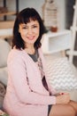 Portrait of pretty adult woman in pink cardigan.