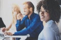 Portrait of pretty african american business woman with afro smiling at the camera.Coworking team in brainstorming Royalty Free Stock Photo