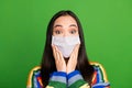 Portrait of pretty amazed delighted girl hands cheeks use facial medical mask isolated over green color background