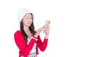Portrait of a pretty Asian teen girl wearing a red dress and white hat happily using a smartphone on a white background Royalty Free Stock Photo