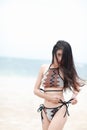 Portrait of pretty beautiful sport fashion woman in bikini posing in summer near the sea and blue sky in sunshine