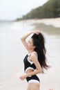 Portrait of pretty beautiful sport fashion woman in bikini posing in summer near the sea and blue sky in sunshine