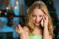 Portrait of pretty blond child-girl on the background of a New Year tree Royalty Free Stock Photo