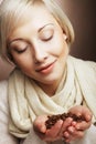 Portrait of pretty blonde girl hold coffee beans in hands Royalty Free Stock Photo