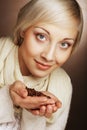 Portrait of pretty blonde girl hold coffee beans in hands Royalty Free Stock Photo