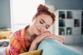 Portrait of pretty carefree satisfied girl closed eyes sit comfy sofa free time nap weekend apartment inside Royalty Free Stock Photo