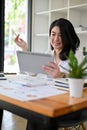 Portrait, Asian businesswoman using digital tablet touchpad at her office desk Royalty Free Stock Photo