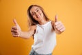 Portrait of a pretty cheerful girl showing thumbs up Royalty Free Stock Photo