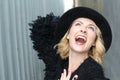 Portrait of pretty cheerful woman wearing black fur dress and modern hat in cold weather day. Walking outdoors in the winter Royalty Free Stock Photo