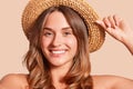 Portrait of pretty cheerful woman wearing straw hat, attractive female looking smiling directly at camera, expresses happyness,