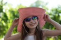 Portrait of pretty cheerful woman wearing white dress and straw pink hat in sunny warm weather day Royalty Free Stock Photo