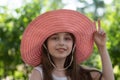 Portrait of pretty cheerful woman wearing white dress and straw pink hat in sunny warm weather day Royalty Free Stock Photo