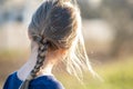 Portrait of a pretty child girl with braid in hair outdoors