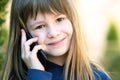 Portrait of pretty child girl with long hair talking on cell phone. Little female kid communicating using smartphone. Children Royalty Free Stock Photo