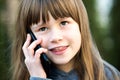 Portrait of pretty child girl with long hair talking on cell phone. Little female kid communicating using smartphone. Children Royalty Free Stock Photo