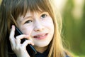 Portrait of pretty child girl with long hair talking on cell phone. Little female kid communicating using smartphone. Children Royalty Free Stock Photo