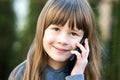 Portrait of pretty child girl with long hair talking on cell phone. Little female kid communicating using smartphone. Children Royalty Free Stock Photo