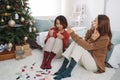 Portrait of pretty confident asian girlfriends make makeup during Holiday. Christmas time