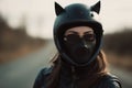 Portrait of a pretty confident woman biker looking at the camera wearing safety helmet