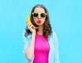 Portrait pretty cool woman with banana having fun over colorful