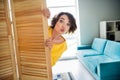 Portrait of pretty cute lady hiding wooden door cupboard choose outfit holiday festive event indoor showroom studio Royalty Free Stock Photo