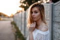 Portrait of a pretty European  young blonde woman with blue eyes with natural make-up in a stylish white lace blouse Royalty Free Stock Photo