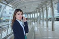 Portrait of pretty face young Asian business woman talking on phone at urban city background. Royalty Free Stock Photo