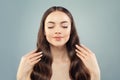 Portrait of pretty fashion model woman relaxing on light blue background. Clear skin, perfect manicure